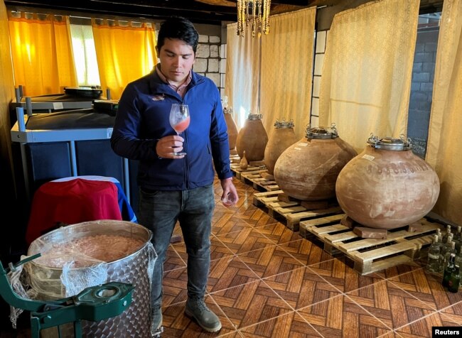 Chilean winemaker Fabian Munoz tastes a sweet criollo (creole) wine in the cellars of the Ayllu wine brand, in the commune of Toconao, in San Pedro de Atacama, Chile May 17, 2022. (REUTERS/Rodrigo Gutierrez)