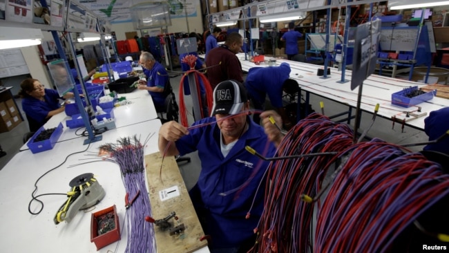 FILE - Employees work at a wire harness and cable assembly manufacturing company that exports to the U.S., in Ciudad Juarez, Mexico, April 27, 2017. (REUTERS/Jose Luis Gonzalez/File Photo)