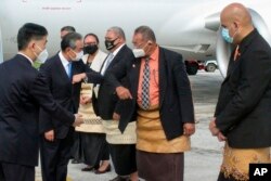 Menteri Luar Negeri China Wang Yi, kedua kiri, disambut di landasan oleh pejabat setibanya di Nuku'alofa, Tonga, Selasa, 31 Mei 2022. (Foto: via AP)