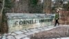 A woman walks by a Cornell University sign on the Ivy League school's campus in Ithaca, NY, on Jan. 14, 2022.