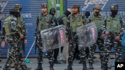 Indian paramilitary soldiers stand guard after clashes with people protesting against the sentencing of Kashmiri separatist leader Mohammed Yasin Malik, in Srinagar, Indian controlled Kashmir, May 25, 2022.