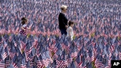 Each year before Memorial Day weekend the Massachusetts Military Heroes Fund places a flag on Boston Common to represent each fallen member of the U.S. military from Massachusetts since the Revolutionary War to the present day. (AP Photo/Steven Senne)