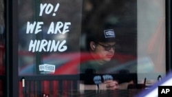 FILE - A hiring sign is displayed at a restaurant in Schaumburg, Ill., April 1, 2022.