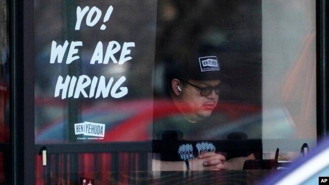 FILE - A hiring sign is displayed at a restaurant in Schaumburg, Ill., April 1, 2022.