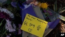 Flowers and a message honoring the victims in Sunday's shooting at Geneva Presbyterian Church are placed outside the church in Laguna Woods, Calif., Monday, May 16, 2022.