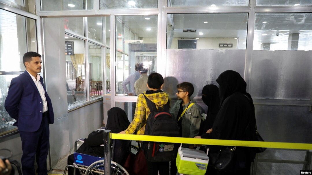 People queue at the departures lounge to board the first commercial flight to be operated from Sanaa Airport, in Sanaa, Yemen, May 16, 2022.