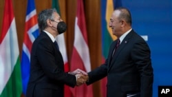 U.S. Secretary of State Antony Blinken and Turkish Foreign Minister Mevlut Cavusoglu meet at the Informal Meeting of NATO Ministers of Foreign Affair in Berlin, Germany, Sunday May 15, 2022.