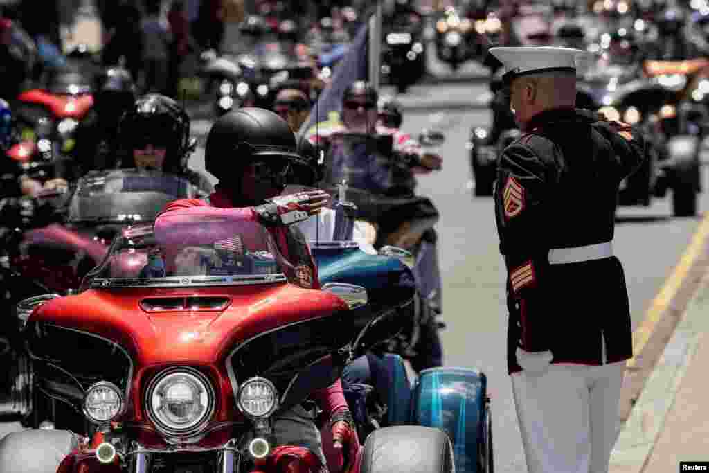 U.S. Marine Corp Staff Sgt. Tim Chambers salutes during the "Rolling to Remember" motorcycle rally, successor to "Rolling Thunder" as it rides through Washington to bring attention to issues faced by veterans, in Washington, May 29, 2022. 