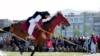 An Afghan man rushes to the target with his horse during spear racing in the sprawling Chaman-e-Huzori park in downtown Kabul, Afghanistan.