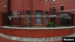 Signage for Massachusetts General Hospital, where a patient is being treated for monkeypox, is pictured on a fence at the hospital in Boston, Massachusetts, U.S., May 19, 2022.