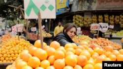 FILE - A woman shops at a fruit and vegetable market in Cairo, Egypt, March 22, 2022.
