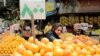 FILE - A woman shops at a fruit and vegetable market in Cairo, Egypt, March 22, 2022.