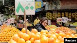 FILE - A woman shops at a fruit and vegetable market in Cairo, Egypt. Taken March 22, 2022.