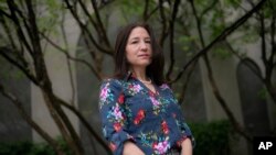 Allyson Jacobs stands for a portrait, May 4, 2022, in New York. For Jacobs, life in her 20s and 30s was about focusing on her career and enjoying the club scene in New York. It wasn't until she turned 40 that she and her husband started trying to have chi