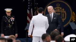 President Joe Biden greets the graduates during the U.S. Naval Academy's graduation and commissioning ceremony at the Navy-Marine Corps Memorial Stadium in Annapolis, Maryland, May 27, 2022.