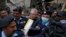FILE - Police officers escort Pakistani journalist Mohsin Baig, center, for his court appearance, in Islamabad, Pakistan, Feb. 16, 2022. Police arrested Baig at his home on unspecified charges, his colleagues and local media said.