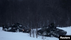 FILE - Swedish army members drive infantry fighting vehicles as part of military exercise called 'Cold Response 2022', gathering around 30,000 troops from NATO member countries plus Finland and Sweden, amid Russia's invasion of Ukraine, in Setermoen in th