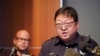 Dallas Police senior corporal Soo Kim addresses reporters in Korean as police Chief Eddie Garcia, left, looks on during a news conference at police headquarters headquarters in Dallas, May 17, 2022. Photo by AP