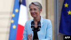 FILE - France's newly appointed Prime Minister Elisabeth Borne delivers a speech during a handover ceremony in the courtyard of the Hotel Matignon, French Prime ministers' official residence, in Paris, May 16, 2022. 