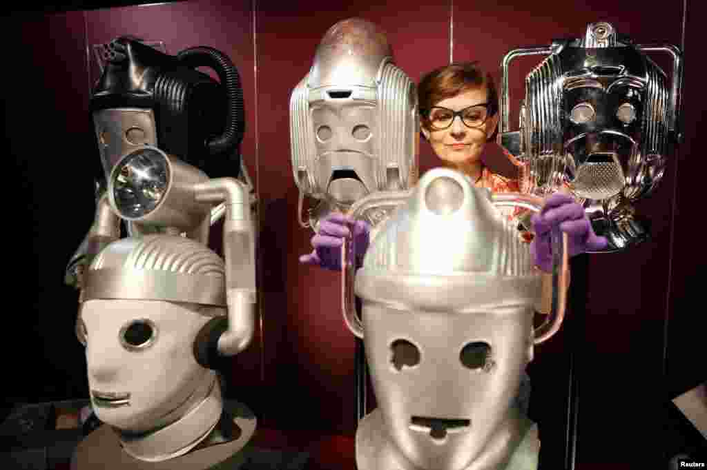 Sculpture conservator Marisa Prandelli adjusts a display of heads of &quot;Cybermen&quot; in the monster vault at the &quot;Doctor Who: Worlds of Wonder&quot; exhibition, which opens at the World Museum later this month, in Liverpool, Britain.