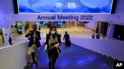 A woman walks up the stairs at the venue of the World Economy Forum prior to the opening of the event in Davos, Switzerland, May 22, 2022.
