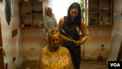 At a hotel converted into temporary housing for displaced families, residents try to approximate normal life by setting up services like a makeshift school and salon on April 28, 2022 in Zaporizhzhya, Ukraine (Yan Boechat/VOA)