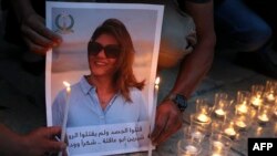 FILE - Family and friends of Al Jazeera reporter Shireen Abu Akleh attend a candle vigil outside the Church of the Nativity in the West Bank city of Bethlehem, May 16, 2022.