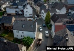 Kirchner drives her coach through a village near her hometown Schupbach near Limburg, Germany, May 19, 2022. (AP Photo/Michael Probst)