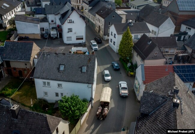 Kirchner drives her coach through a village near her hometown Schupbach near Limburg, Germany, May 19, 2022. (AP Photo/Michael Probst)