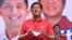 Philippine presidential candidate Ferdinand Marcos Jr. delivers a speech prior to introducing his son Ferdinand Alexander "Sandro" Marcos (back right) during a rally in Laoag, Ilocos Norte province, north of Manila, March 25, 2022.
