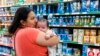 Yury Navas, 29, of Laurel, Md., kisses her two-month-old baby Jose Ismael Gálvez, while looking for formula at Superbest International Market in Laurel, Md., May 23, 2022.