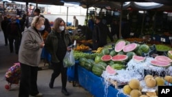 FILE - People buy local products at an open air market, in Ankara, Turkey, May 8, 2022. Inflation in Turkey soared to nearly 70% in April, official data showed, as skyrocketing prices eat away at earnings and put even basic necessities out of reach for many households.