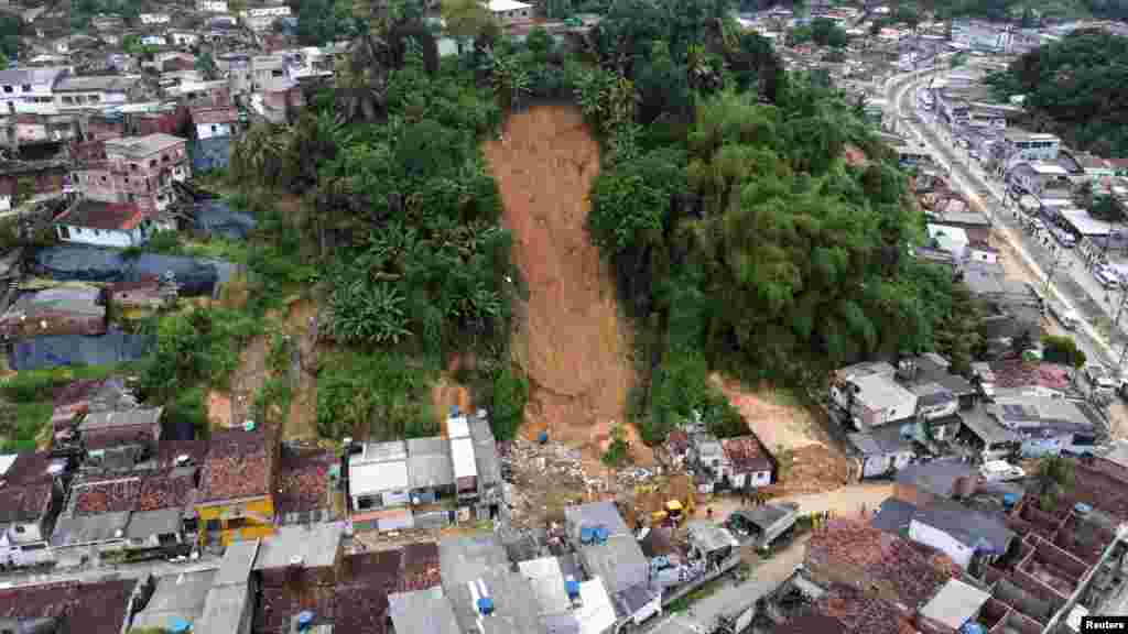 Firefighters, volunteers and army officers work on the site where a house collapsed due to a landslide caused by heavy rains at Jardim Monte Verde, in Ibura neighborhood, in Recife, Brazil, May 29, 2022.
