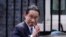Japanese Prime Minister Fumio Kishida waves at the media as he leaves after his meeting with British Prime Minister Boris Johnson, at 10 Downing Street in London, May 5, 2022.
