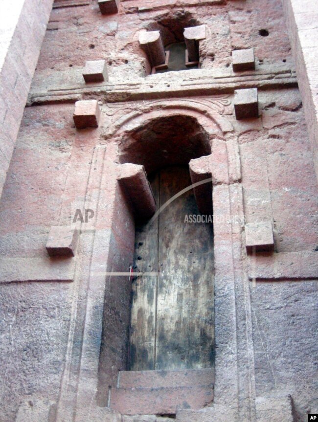 This April 2010 photo shows a door to one of the churches at Lalibela, Ethiopia. Lalibela has a winding complex of 11 churches cut out of the rust-red granite tucked into a windswept moonscape.