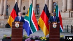 German Chancellor Olaf Scholz, left, and South African President Cyril Ramaphosa conduct a joint press conference during Scholz's visit at the Union Buildings in Pretoria on May 24, 2022.