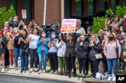 FILE - Supporters of both actors Johnny Depp and Amber Heard rally outside of the Fairfax County Courthouse, in Fairfax, Va., May 27, 2022.