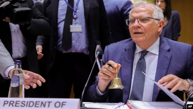 European Union foreign policy chief Josep Borrell rings the bell to announce the beginning of the meeting of EU foreign ministers at the European Council building in Brussels, May 16, 2022.