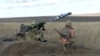 FILE - In this image taken from footage provided by the Ukrainian Defense Ministry Press Service, a Ukrainian soldiers use a launcher with US Javelin missiles during military exercises in Donetsk region, Ukraine, Wednesday, Jan. 12, 2022. 