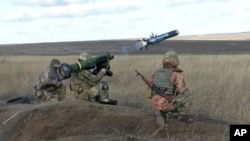 FILE - In this image taken from footage provided by the Ukrainian Defense Ministry Press Service, a Ukrainian soldiers use a launcher with US Javelin missiles during military exercises in Donetsk region, Ukraine, Wednesday, Jan. 12, 2022.