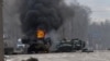 ARCHIVO - Un vehículo blindado de transporte de personal ruso arde en medio de vehículos utilitarios ligeros dañados y abandonados después de los combates en Kharkiv, la segunda ciudad más grande en Ucrania, el 27 de febrero de 2022. 