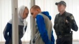 Russian Sgt. Vadim Shishimarin listens to his translator during a court hearing in Kyiv, Ukraine, May 23, 2022. 