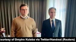 Ukraine's Foreign Minister Dmytro Kuleba poses for a photo with U.S. Secretary of State Antony Blinken during a meeting in Berlin, Germany, in this image posted on Twitter on May 15, 2022.