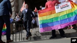 FILE - Jim Obergefell, the named plaintiff in the Obergefell v. Hodges Supreme Court case that legalized same sex marriage nationwide, arrives for a news conference on the steps of the Texas Capitol, June 29, 2015, in Austin, Texas.
