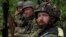 Ukrainian servicemen take rest in a recently retaken village north of Kharkiv, east Ukraine, May 15, 2022