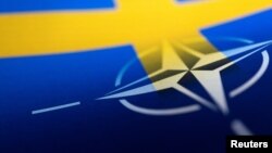 FILE - Swedish and NATO flags are seen printed on paper this illustration taken Apr. 13, 2022. 