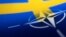 FILE - Swedish and NATO flags are seen printed on paper this illustration taken Apr. 13, 2022. 