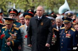 Presiden Rusia Vladimir Putin, menghadiri upacara peletakan karangan bunga di Makam Prajurit Tak Dikenal setelah parade memperingati 77 tahun berakhirnya Perang Dunia II, di Moskow, 9 Mei 2022. (Foto: via AP)