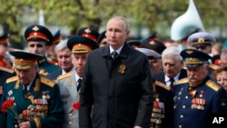 Russian President Vladimir Putin, attends a wreath-laying ceremony at the Tomb of the Unknown Soldier after a parade marking the 77th anniversary of the end of World War II, in Moscow, May 9, 2022. (Sputnik, Kremlin Pool Photo via AP)