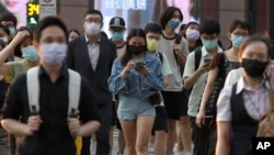 FILE - People wear face masks to help protect against the spread of the coronavirus in Taipei, Taiwan, Sept. 30, 2021. 